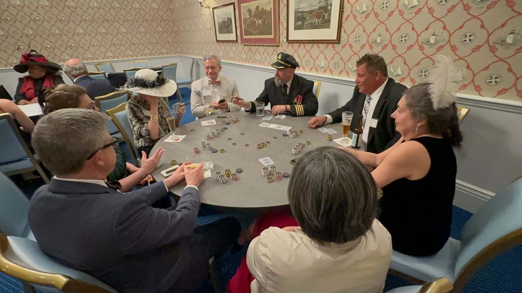 Captain Smith, played by Scott Cramton, engages guests of the 2023 Grand Hotel Titanic Immersive Weekend in a poker tournament
